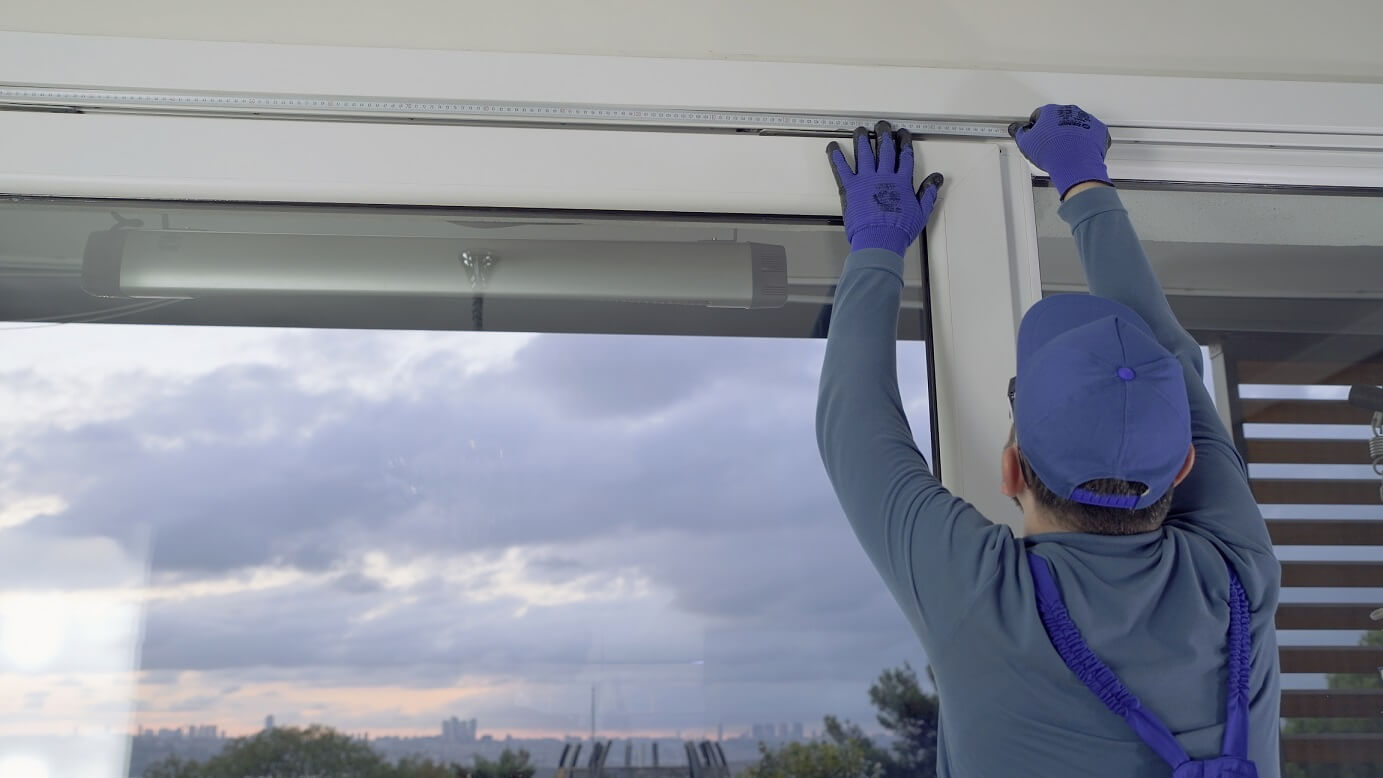 window contractor installing window treatment