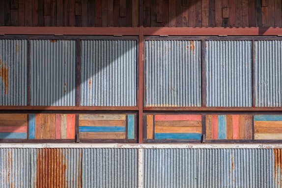 A wall with corrugated metal panels