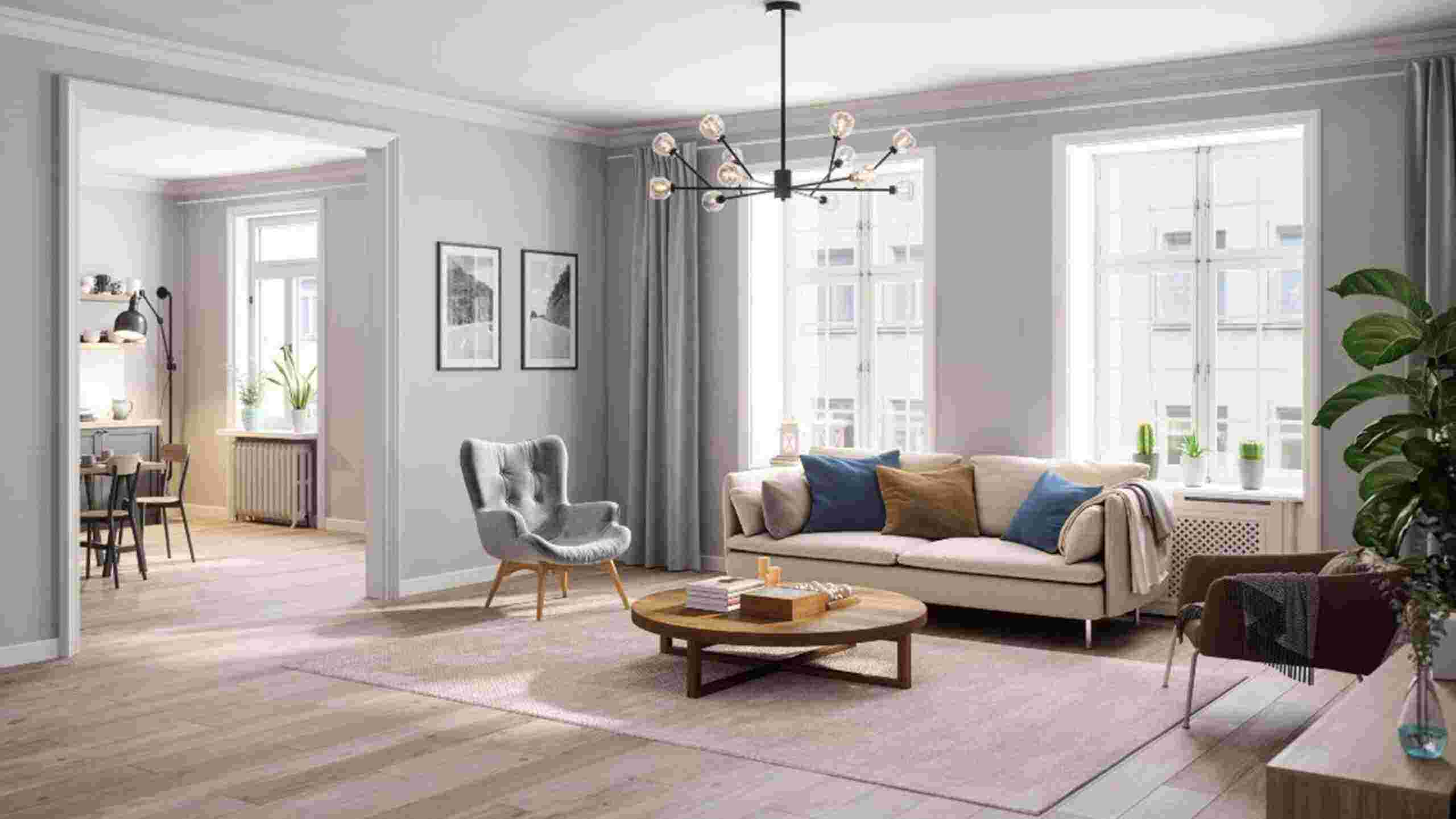 A living room showing a couch, chair, and table, with casement windows installed in Columbus, OH.