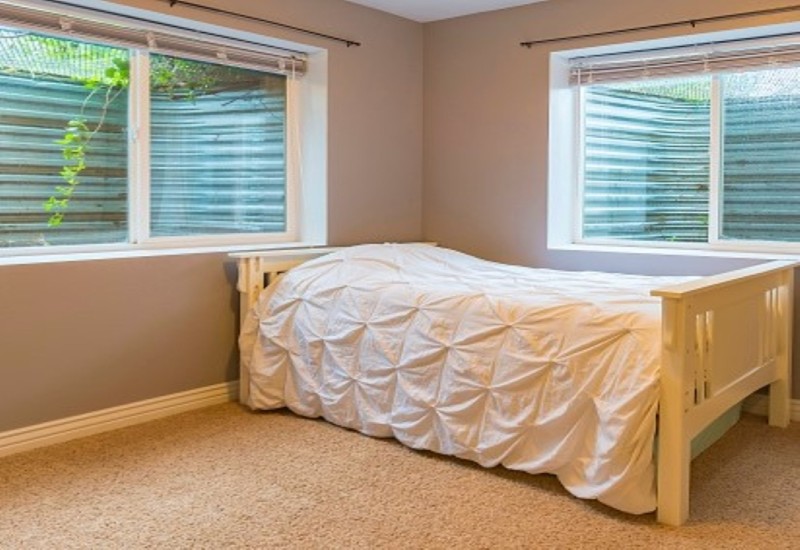Cozy bedroom in Columbus, OH, with a bed and large windows allowing natural light