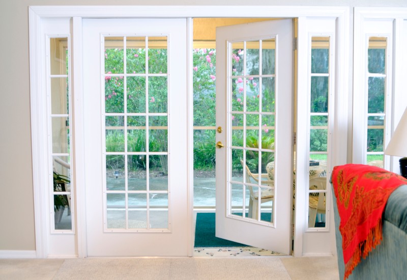 White patio doors with glass panels opening to a garden view in a home located in Columbus, Ohio