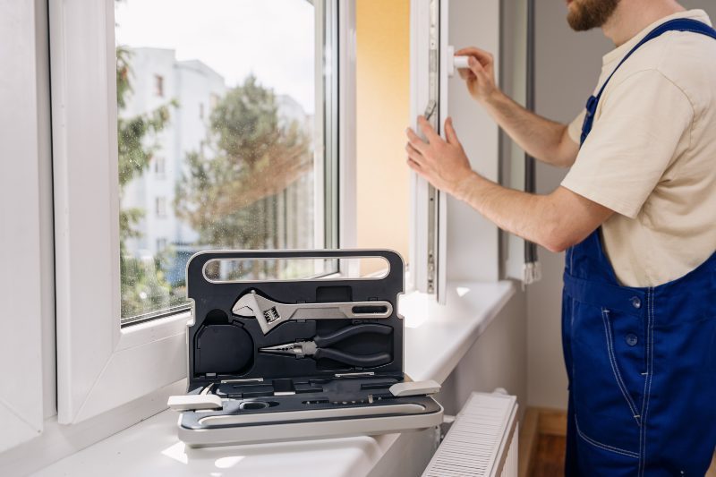 Window installation technician adjusting a newly installed residential window