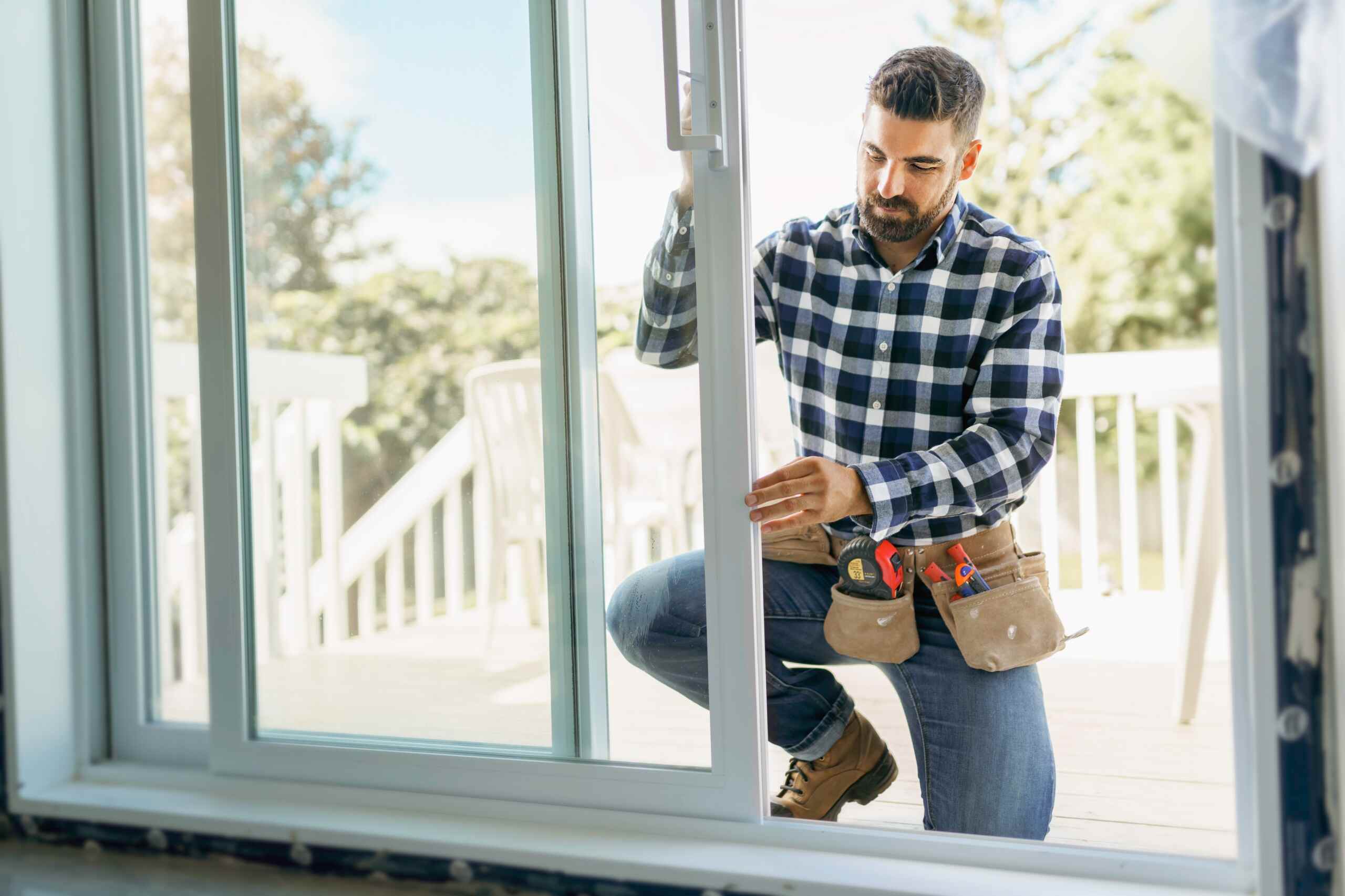 Professional installer adjusting a sliding glass patio door